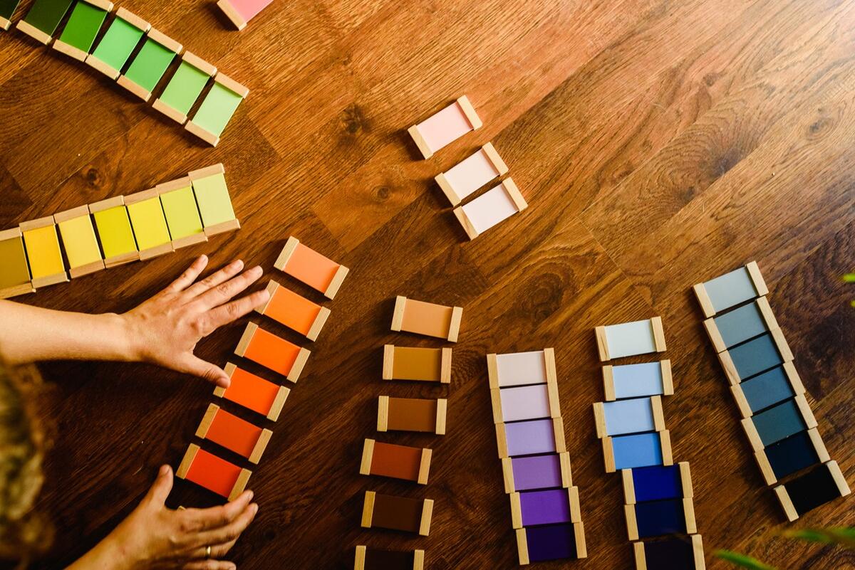 Child arranging Montessori color tablets